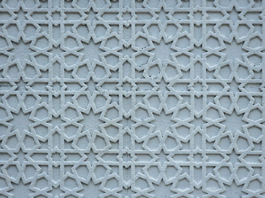 A close up of a white wall with a pattern on it