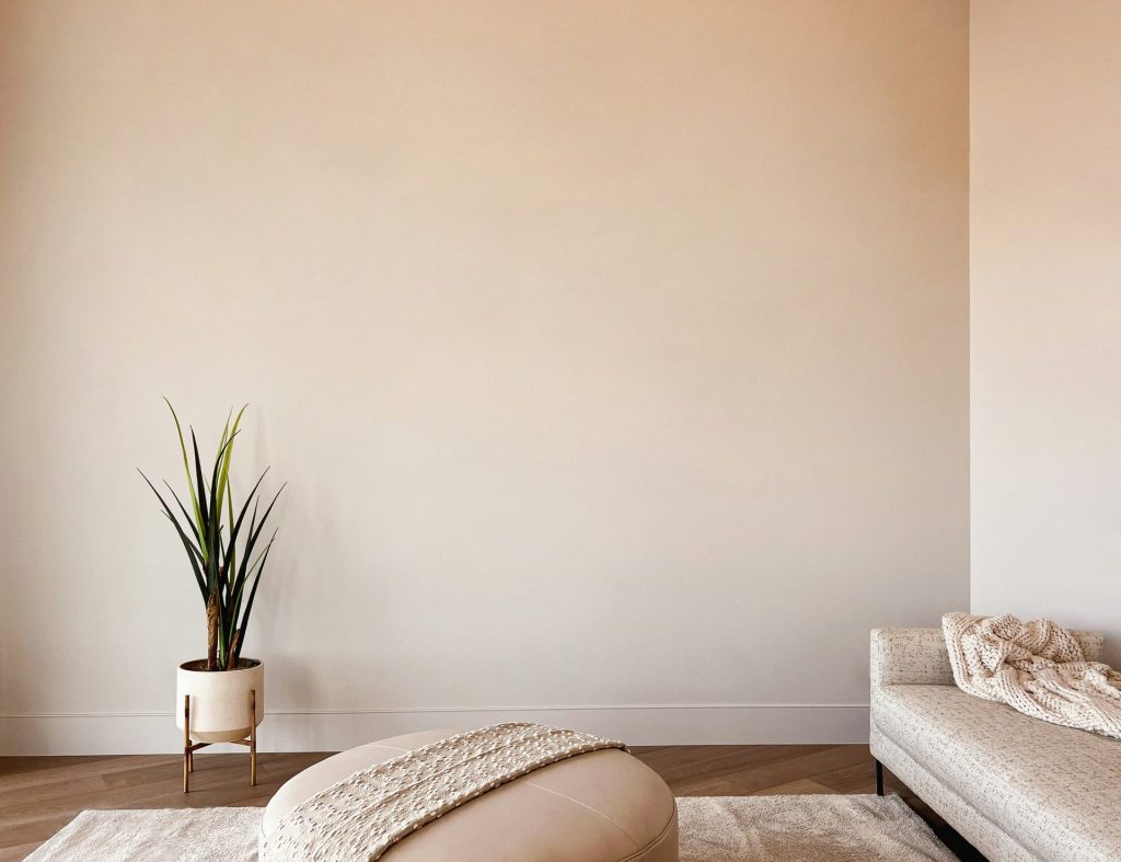 a room filled with furniture and vase of flowers sitting on a bed